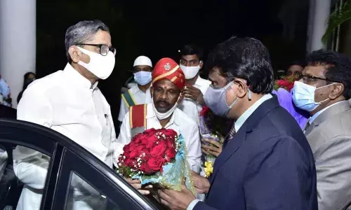 Anantapur district officials receiving Chief Justice of India Justice N V Ramana in Puttaparthi on Sunday