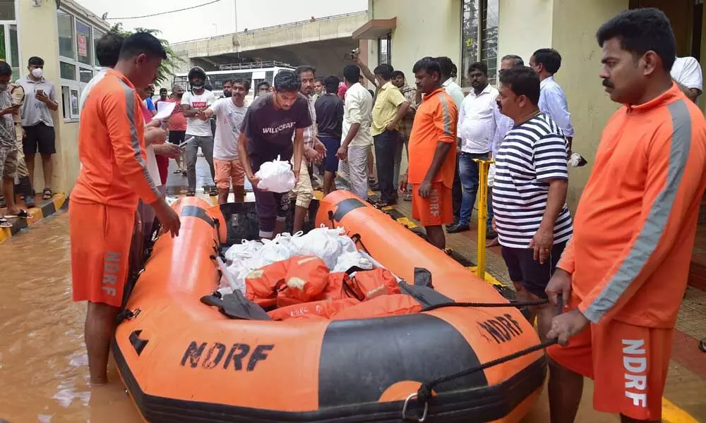 National Disaster Response Force (NDRF) during an evacuation operation of the residents of Kendriya Vihar from a flooded area due to overnight rain and a breach of the adjacent Yelhanaka lake wall in Bengaluru on Monday