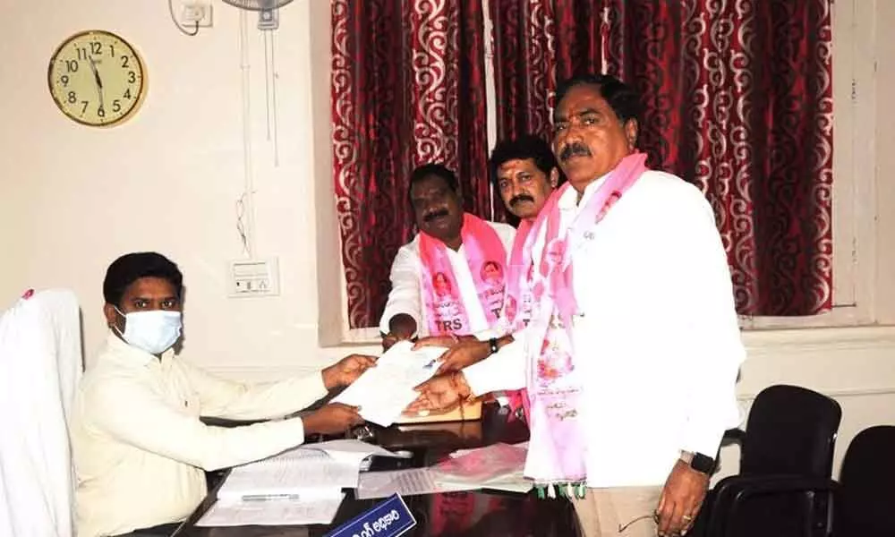 Pochampally Srinivas Reddy (center) submitting nomination papers to District Collector and Election Officer B Gopi at the Warangal Collectorate on Monday. Minister for Panchayat Raj Errabelli Dayakar Rao and MLA Aroori Ramesh are also seen.