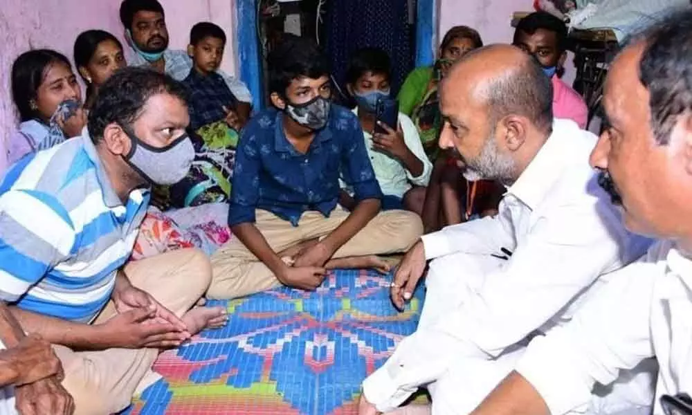 BJP leader B Sanjay Kumar speaking to family members of drowned students at Sircilla on Monday