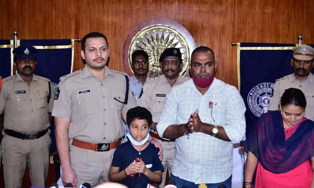 Krishna district Superintendent of Police Siddharth Kaushal with the rescued child