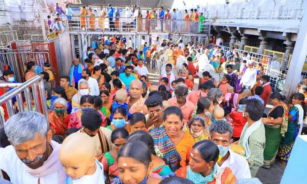 Devotees waiting for darshan in Vemulawada temple on Monday