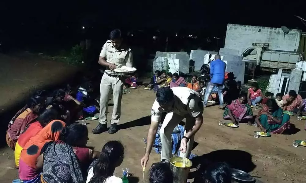 Police serving food to workers from Odisha in Mylavaram on Monday night