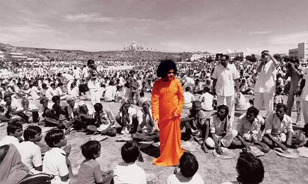 File picture of Sri Sathya Sai Baba blessing his devotees