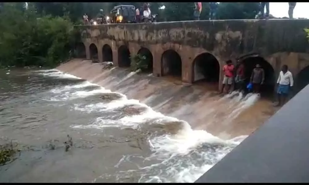 Water flowing from Sankara Rayalapeta tank after sluice gates lifted as it was brimming with huge inflows due to rains.