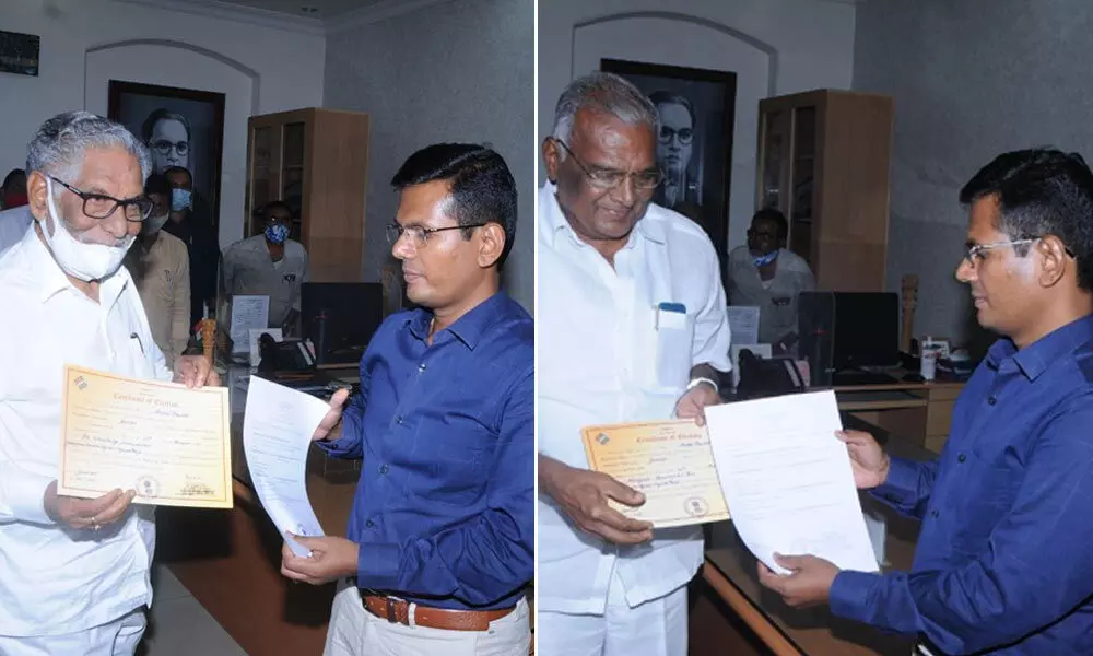 Dr Ummareddy Venkaetswarulu, Murugudu Hanumantha Rao receiving certificate of election to the Legislative Council  from the returning officer at the Collectorate in Guntur city on Friday
