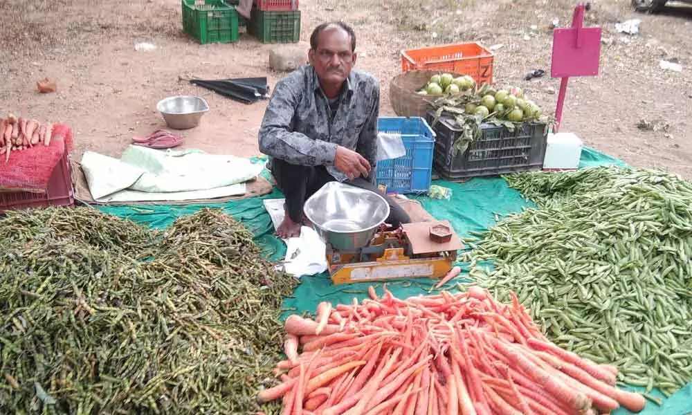 A man selling vegetables at the market in Adilabad