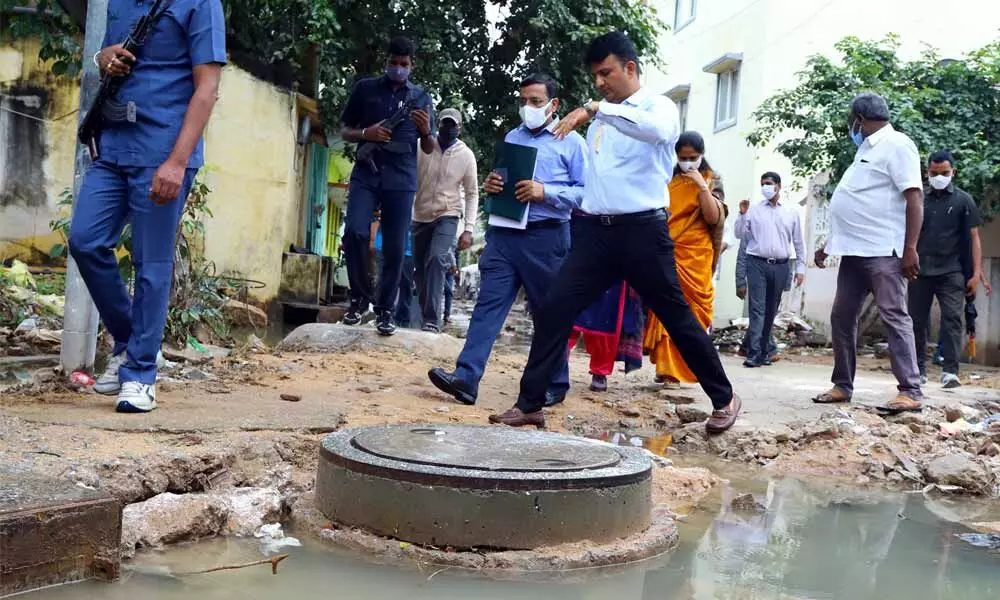 Tirupati Municipal Corporation commissioner P S Girisha inspecting Sri Krishna Nagar where the floodwater is still stagnated on streets, in Tirupati on Saturday