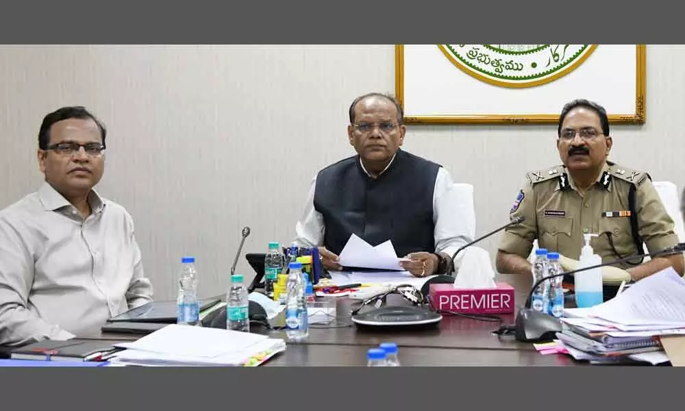 Chief Secretary Somesh Kumar and DGP M Mahender Reddy speaking at a video conference with District Collectors, SPs, CPs and other officials from BRKR Bhavan, Hyderabad on Saturday
