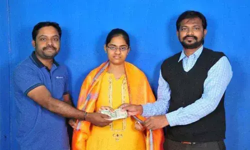 NGO officials Mohammad Azam and Patha Santosh Kumar handing over the amount to Narmeta Navya Sri in Karimnagar on Sunday