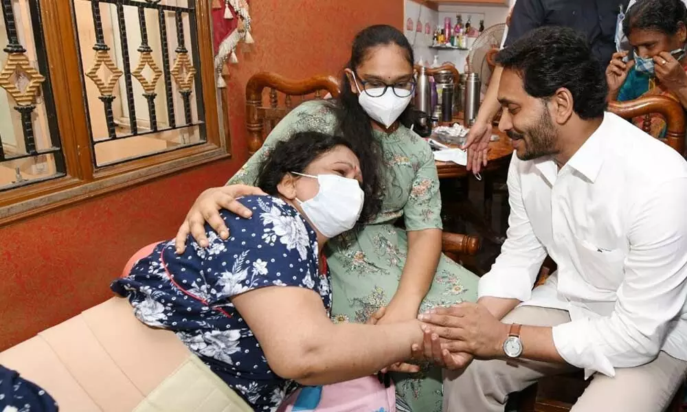 Chief Minister YS Jagan Mohan Reddy enquires about the health of Vijayakumari in a flood-affected area in Tirupati on Friday