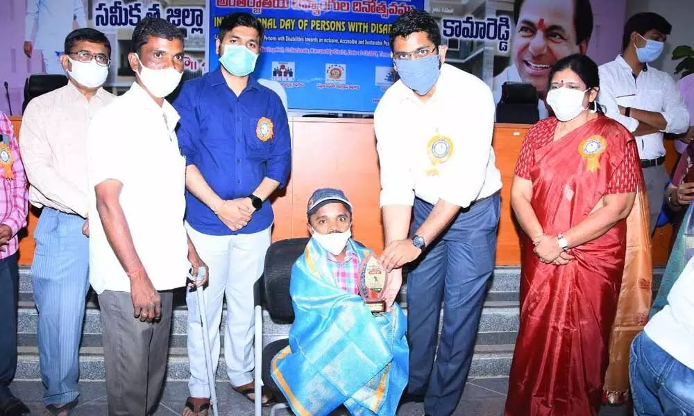 District Collector Jitesh V Patil and ICDS Disabled PD Saraswati felicitating a disabled boy at a programme at the integrated district office in Kamareddy on Friday