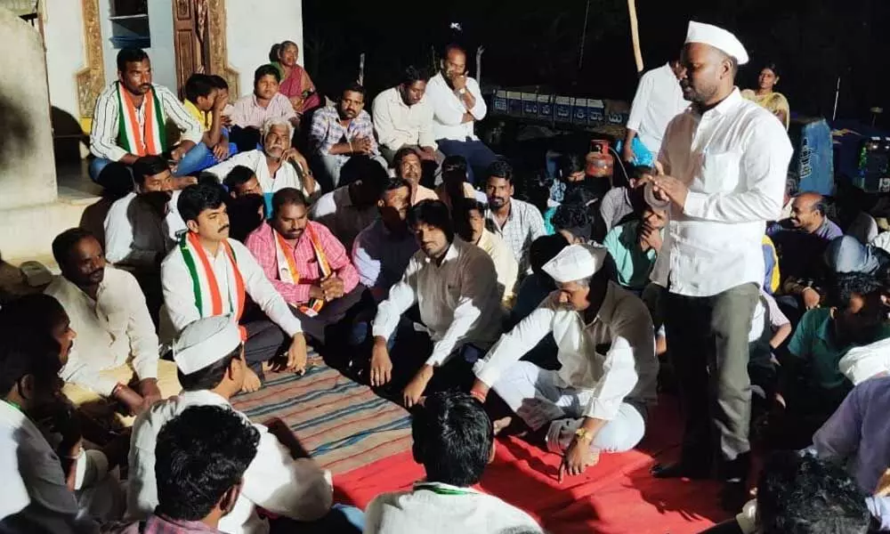Kollapur Congress leader interacting with the villagers during a ‘Palle Nidra’ programme in Tellarallapally village of Pangal mandal in Wanaparthy district