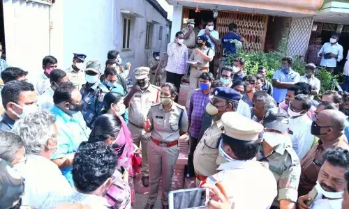 Prakasam SP Malika Garg speaking to the locals on the double murder case at Tangutur on Saturday