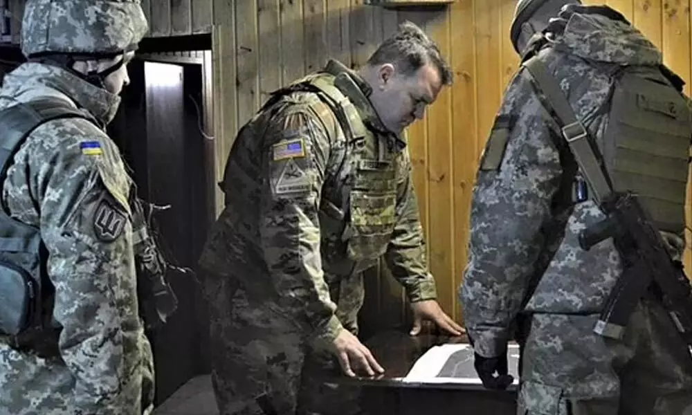 In this photo taken on Nov. 19, 2021, Attache of the Land Forces at the US Embassy in Ukraine Colonel Brandon Presley looks at the map. (Photo | AP)