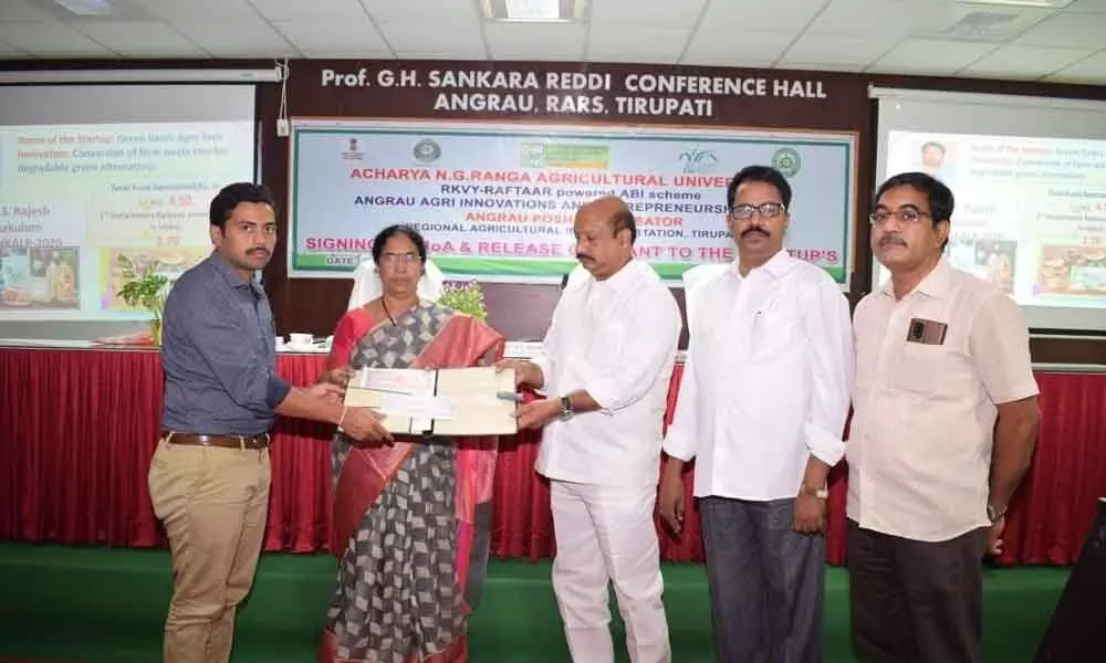ANGRAU board member TV Murali Nath Reddy and others handing over cheques to entrepreneurs to set up their start-ups at RARS of SV Agriculture College in Tirupati on Monday