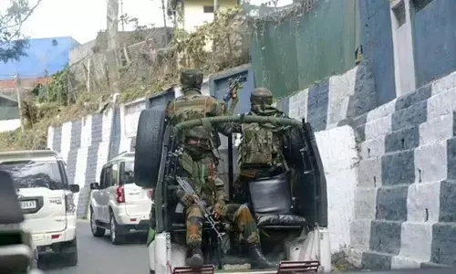 Indian army soldiers ride past the main town in a convoy in Kohima, capital of northeastern Nagaland state, India. (Photo | AP)