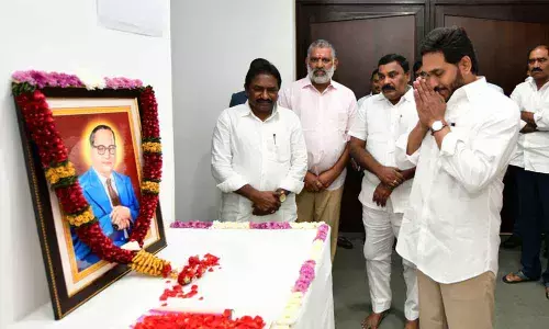 Chief Minister Y S Jagan Mohan Reddy pays floral tributes to Dr B R Ambedkar on his death annversary at his camp office in Tadepalli on Monday