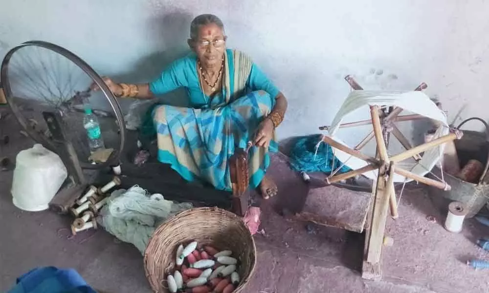 An old woman spinning the yarn on a spindle at Kamalapur in Hanumakonda district on Tuesday