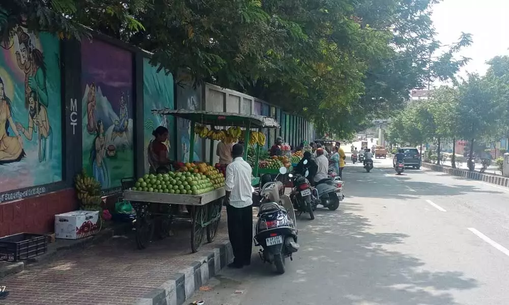 Fruit vendors occupy the footpath near Padmavathi Girls High School