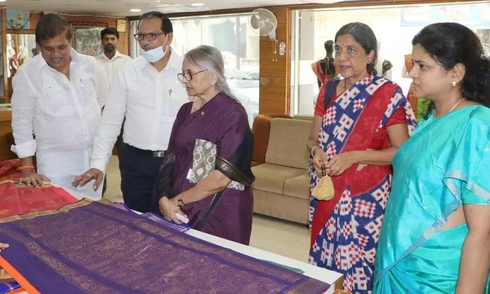 AP Crafts Councils secretary Ranjana and treasurer Jayasree along with APCO managing director Nagarani and chairman Chillapally Venkata Naga Mohan Rao inspecting handloom sarees in Vijayawada on Tuesday