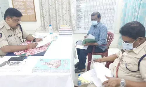 Superintendent of Police M Ravindanath Babu checking records at III Town Police station in Kakinada on Tuesday