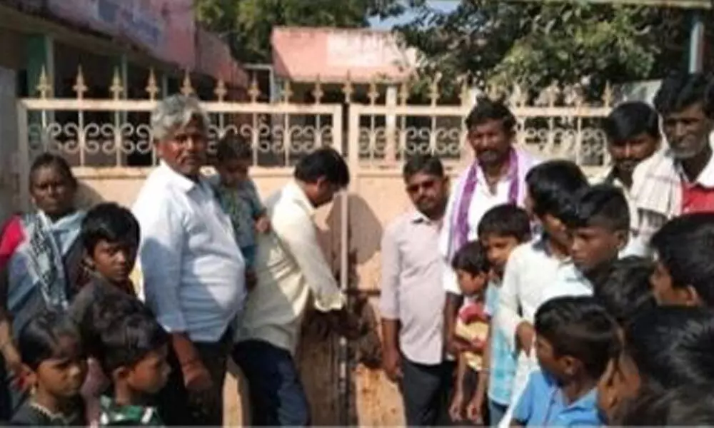 Parents of students locking the gates of a school in Soganur village in Yemmiganur mandal on Wednesday.