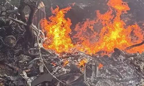 Fire at the scene of the wreckage where a helicopter carrying Gen. Bipin Rawat and others crashed in Tamil Nadu