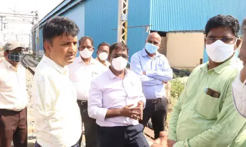 Divisional Railway Manager Venkataramana Reddy and Municipal Commissioner P S Girisha inspecting the railway bridge at Rayalacheruvu in Tirupati on Wednesday