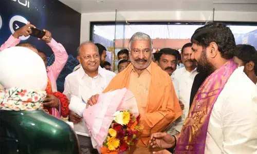 Robo Diner founder M N Bharath Kumar Reddy presenting a bouquet brought by Robo to Panchayat Raj Minister Peddireddi Ramachandra Reddy, in Tirupati on Thursday.