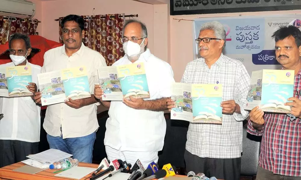 Book Festival Society president T Manohar Naidu and members releasing a brochure on the 31st Book Festival at Book Festival Society office in Vijayawada on Saturday