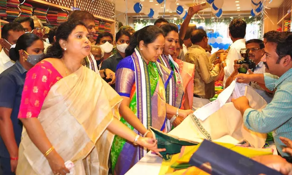 Home Minister Mekathoti Sucharitha and MLA Undavalli Sridevi having a glance at saris after inaugurating the APCO handlooms showroom in Guntur on Tuesday