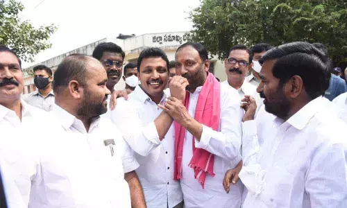 Nagarjuna Sagar MLA Nomula Bhagath offering sweet to MC Koti Reddy on his victory. Minister Jagadish Reddy and MLA K Bhupal  Reddy also seen