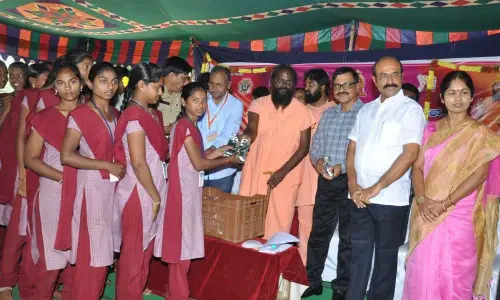 Himalaya Guruji, founder of Santhi Ashramam Trust, distributing free food packets to students of KVR Government Junior College in Kurnool (file photo)