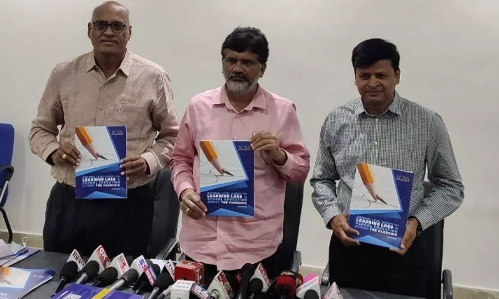 TRSMA and NISA leaders Y Shekhar Rao and E Prasad Rao releasing a national educational survey report in Karimnagar on Wednesday