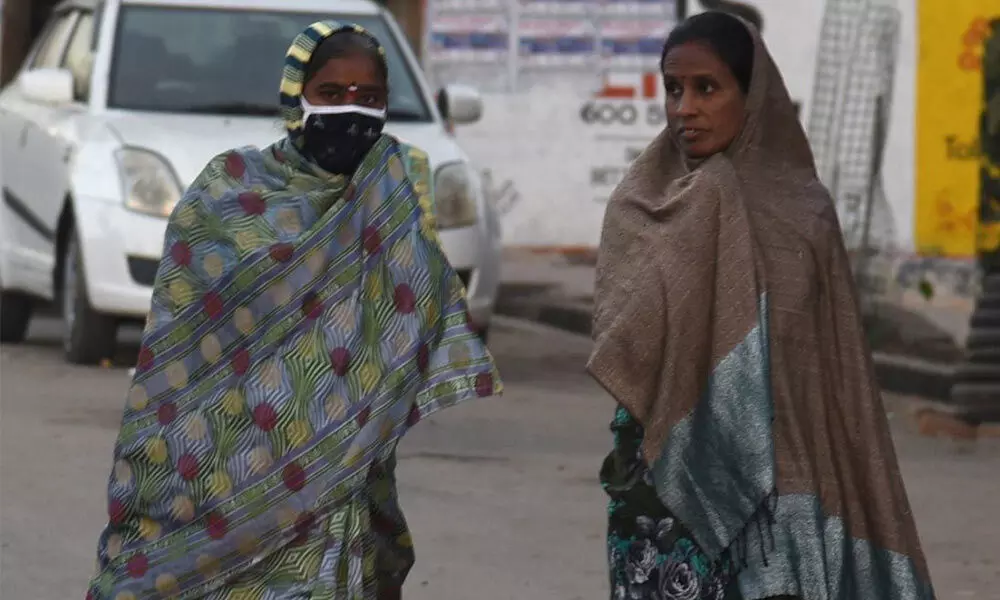 Women covering themselves with blankets to stay warm