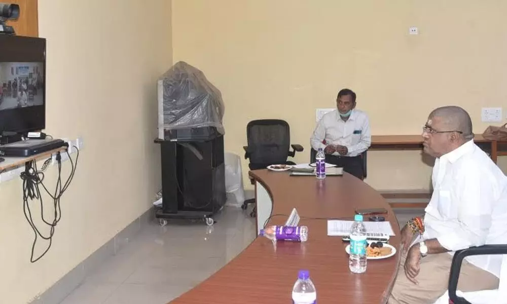 Tourism Minister M Srinivasa Rao participating in a virtual meeting in Visakhapatnam on Saturday