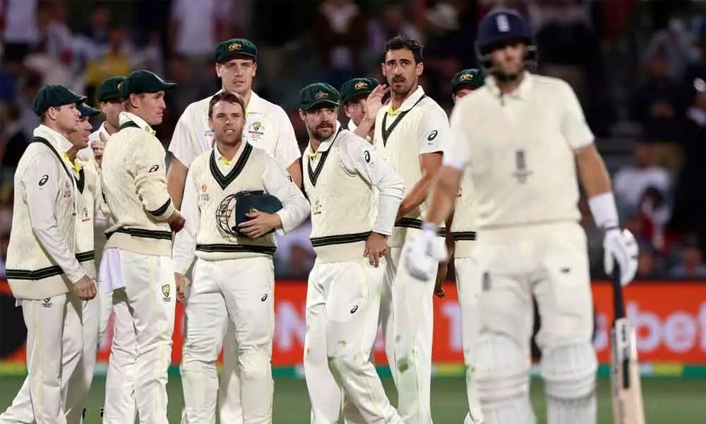 Australian players watch as Englands Joe Root (right) leaves the field after he was dismissed by Mitchell Starc (second right) during the fourth day of their Ashes Test match in Adelaide, Australia on Sunday