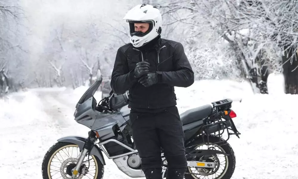 Try to stay warm, by wearing helmet, gloves, leather jacket and shoes.