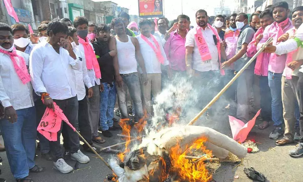 TRS supporters burn an effigy of PM Modi protesting against the  anti-farmer policies of the Central government