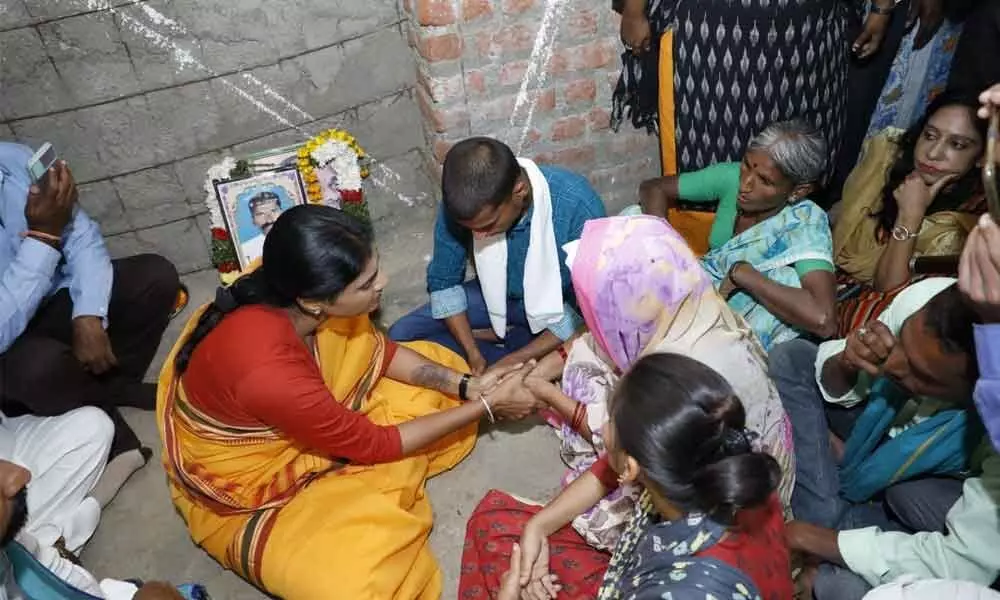 Sharmila consoling the family of farmer Kummari Rajaiah who committed suicide in Sadashivanagar mandal on Monday.