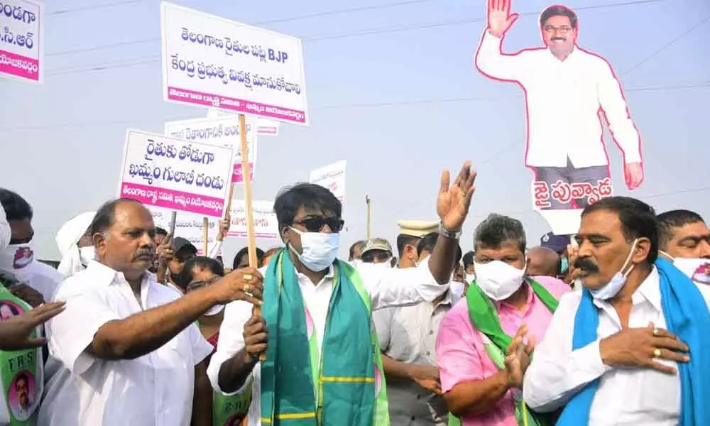 Minister for Transport Puvvada Ajay Kumar displaying placards and taking part in a protest programme against the Central government, in Raghunathapalem mandal  on Monday.