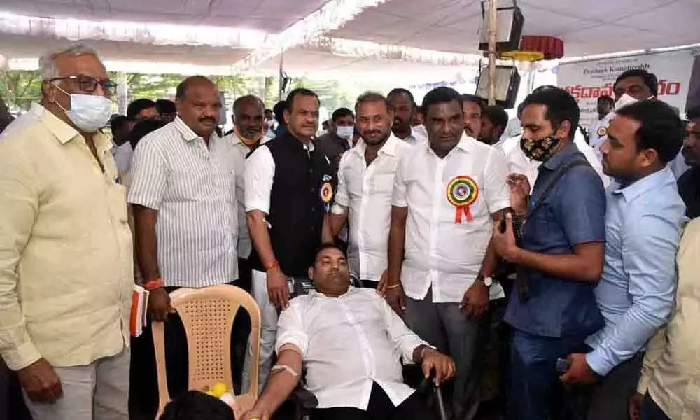 Congress party worker donating blood at a camp held at Komatireddy Prateek Memorial Government Junior college for boys in Nalgonda on Monday