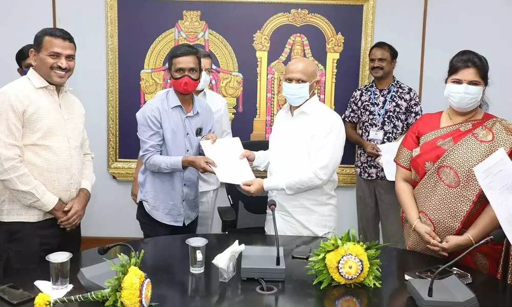 TTD additional O A V Dharma Reddy hands over the appoint order to an outsourced employee who was brought under the newly-set up corporation by TTD for outsourced employees at Tirupati on Tuesday