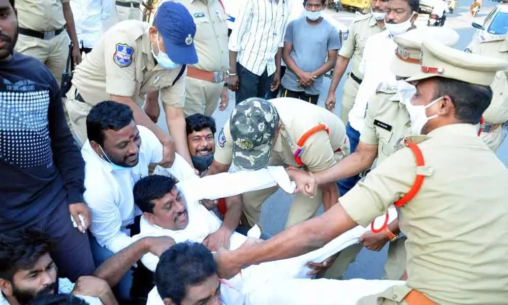 Police arresting BJP district chief Galla Satyanaryana and other leaders in Khammam on Tuesday