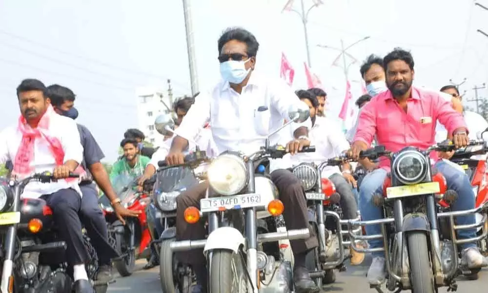 Khammam: Minister rides bike to distribute marriage scheme cheques