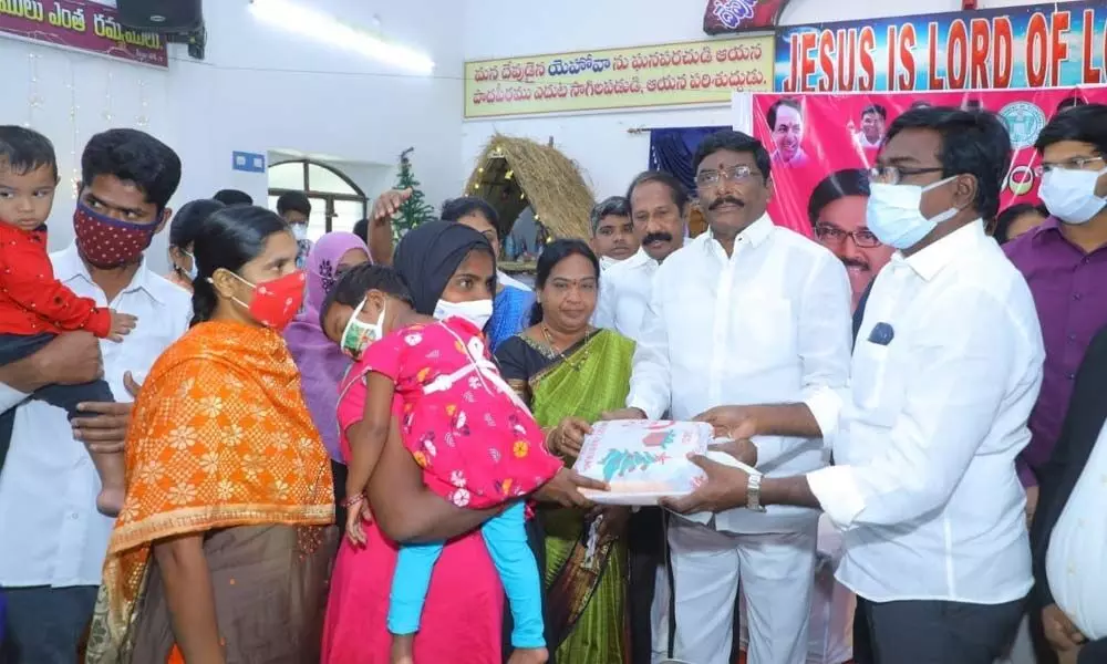 Transport Minister Puvvada Ajay Kumar distributing clothes to poor Christians in Khammam on Wednesday