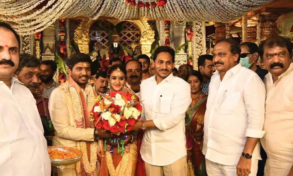 Chief Minister Y S Jagan Mohan Reddy presenting a bouquet to the newly-wed couple at the marriage function of the son of  Panyam MLA Katasani Rambhupal Reddy at Panchalingala village in Kurnool district on Wednesday