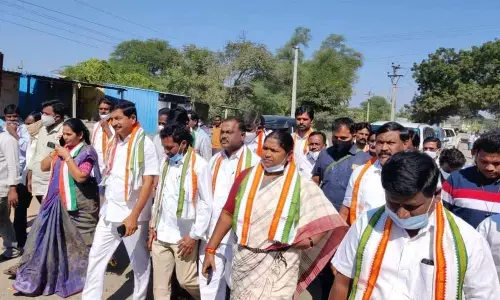 Congress cadres led by Mulugu MLA Seethakka alias Danasari Anasuya and TPCC vice-president Vem Narender Reddy taking out a rally at Nellikuduru in Mahabubabad district on Wednesday