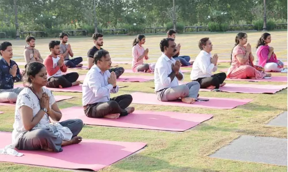 SRM University-AP students, faculty and other members doing yoga at Manthena Satyanarayana Arogyalayam on the banks of River Krishna in Vijayawada on Thursday